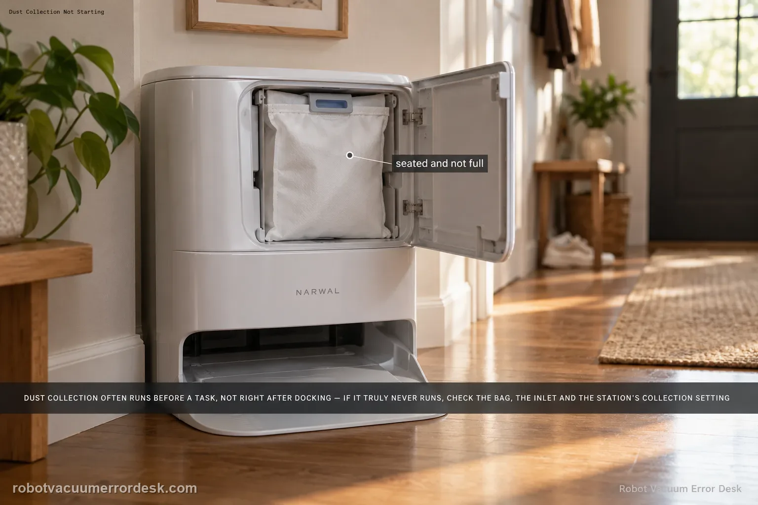 A Narwal Freo Z Ultra station in a hallway nook with its dust-bag compartment cover open, the bag seated in its holder.