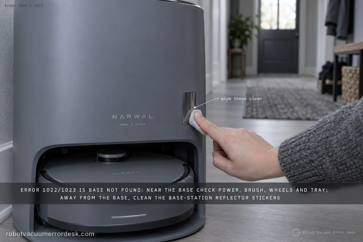 A fingertip wiping one of the small reflective stickers on the front face of a Narwal Freo Z Ultra base station, Error 1022/1023 tagged in the corner.
